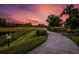 Curved community path alongside a tranquil pond and lush landscape at 5309 Greenbrook Dr, Sarasota, FL 34238