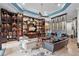 Living room with custom shelving, comfortable seating, and a stained-glass window at 5309 Greenbrook Dr, Sarasota, FL 34238
