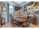 Elegant formal dining room featuring a large wood table, art-filled walls, and plush seating at 5309 Greenbrook Dr, Sarasota, FL 34238
