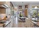 Eat-in kitchen with granite counters, custom cabinetry, and view to Gathering room at 5309 Greenbrook Dr, Sarasota, FL 34238