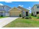Tan house with two-car garage and landscaped yard at 3902 Willow Hammock Dr, Palmetto, FL 34221