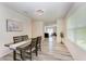Dining room with a wood table, four chairs, and wood-look floors at 3902 Willow Hammock Dr, Palmetto, FL 34221