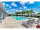 Community pool with lounge chairs and palm trees at 3902 Willow Hammock Dr, Palmetto, FL 34221