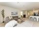 Open living room with kitchen views and access to other rooms at 3902 Willow Hammock Dr, Palmetto, FL 34221