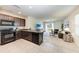 Kitchen with dark cabinets, granite counters, and stainless steel appliances at 3902 Willow Hammock Dr, Palmetto, FL 34221