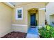 Inviting entryway with a blue door and landscaping at 3902 Willow Hammock Dr, Palmetto, FL 34221