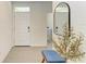 Bright foyer with a bench, mirror, and laundry access at 3902 Willow Hammock Dr, Palmetto, FL 34221