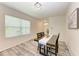 Dining room with a wood table, four chairs, and large window at 3902 Willow Hammock Dr, Palmetto, FL 34221