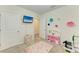 bedroom with built-in shelving and a play area at 3902 Willow Hammock Dr, Palmetto, FL 34221