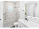 Bathroom with marble shower, white vanity, and a toilet at 4593 Targee Ave, North Port, FL 34287
