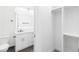 Modern bathroom with white cabinets, a large mirror, and a walk-in closet at 4593 Targee Ave, North Port, FL 34287
