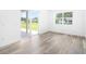 Bright bedroom with sliding glass doors and wood-look flooring at 4593 Targee Ave, North Port, FL 34287