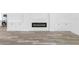 Modern electric fireplace with white shiplap surround and built-in shelving at 4593 Targee Ave, North Port, FL 34287