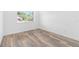 Bright bedroom with wood-look flooring and a large window at 4593 Targee Ave, North Port, FL 34287