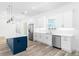 Modern kitchen with white cabinets, stainless steel appliances and quartz countertops at 4593 Targee Ave, North Port, FL 34287