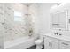 Bathroom with marble shower, white vanity, and a bathtub at 4593 Targee Ave, North Port, FL 34287