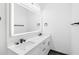 Double vanity bathroom with white cabinets and a large mirror at 4593 Targee Ave, North Port, FL 34287
