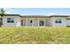 House exterior with covered patio and grassy yard at 4593 Targee Ave, North Port, FL 34287