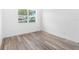 Bright bedroom with wood-look flooring and a large window at 4593 Targee Ave, North Port, FL 34287