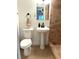 Compact bathroom featuring a pedestal sink, toilet, and step-in shower with modern fixtures at 3637 Mineola Dr, Sarasota, FL 34239