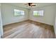 Bright bedroom with wood-look floors and a modern ceiling fan at 3637 Mineola Dr, Sarasota, FL 34239