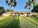 Well-maintained lawn with palms, landscaping, and a beige single-story home at 3637 Mineola Dr, Sarasota, FL 34239
