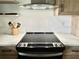Modern kitchen featuring sleek black cooktop, vent hood, and light wood cabinets at 3637 Mineola Dr, Sarasota, FL 34239