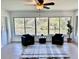 Bright sunroom with floor to ceiling windows offering tranquil water views and modern furniture at 3637 Mineola Dr, Sarasota, FL 34239