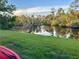 Scenic water view with lush landscaping and tranquil canal reflecting the beautiful blue sky at 3637 Mineola Dr, Sarasota, FL 34239