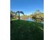 Beautiful waterfront view with a palm tree on a lush green lawn and scenic river view at 3637 Mineola Dr, Sarasota, FL 34239