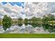 Tranquil community pond with scenic reflections of homes and lush greenery at 14939 Amberjack Ter # 102, Lakewood Ranch, FL 34202