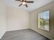 Simple bedroom with ceiling fan and window with blinds at 14939 Amberjack Ter # 102, Lakewood Ranch, FL 34202