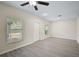 Bright living room with wood-look floors and ceiling fan at 14939 Amberjack Ter # 102, Lakewood Ranch, FL 34202