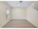 Neutral-toned living room with large window and wood-look floors at 14939 Amberjack Ter # 102, Lakewood Ranch, FL 34202