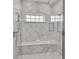 Large walk-in shower with marble tile and built-in seat at 2510 Gulf N Dr, Bradenton Beach, FL 34217