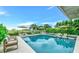 Inviting pool with swim-up seating and lounge chairs at 2510 Gulf N Dr, Bradenton Beach, FL 34217