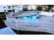 Community pool with surrounding patio furniture at 5906 Garden Ln # A22, Bradenton, FL 34207