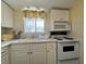 Well-equipped kitchen with white cabinetry and appliances at 5906 Garden Ln # A22, Bradenton, FL 34207