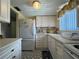 Efficient kitchen with white cabinets and appliances at 5906 Garden Ln # A22, Bradenton, FL 34207