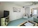 Living room with TV, seating and view to kitchen at 5906 Garden Ln # A22, Bradenton, FL 34207