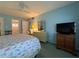 King-size bed, dresser, and TV in this bright bedroom at 5906 Garden Ln # A22, Bradenton, FL 34207