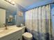 Clean bathroom with starfish-themed shower curtain at 5906 Garden Ln # A22, Bradenton, FL 34207