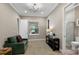Relaxing sitting room with a comfortable sofa and access to a bathroom at 12014 Perennial Pl, Lakewood Ranch, FL 34211