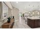 Open kitchen boasts granite island, stainless steel appliances, and white cabinetry at 12014 Perennial Pl, Lakewood Ranch, FL 34211