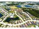 Aerial view of houses, lakes, and parks in a residential community at 12014 Perennial Pl, Lakewood Ranch, FL 34211
