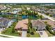 Aerial view of a luxury home community with lake and houses at 12014 Perennial Pl, Lakewood Ranch, FL 34211