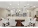 Modern kitchen with white cabinets, granite countertops, and a large island at 12014 Perennial Pl, Lakewood Ranch, FL 34211