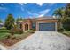 Single story house with gray paver driveway and landscaping at 12014 Perennial Pl, Lakewood Ranch, FL 34211
