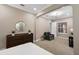 Spacious bedroom with plush carpet, large windows, and a sitting area at 12014 Perennial Pl, Lakewood Ranch, FL 34211