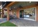 Outdoor kitchen and patio with seating area and sliding glass doors at 12014 Perennial Pl, Lakewood Ranch, FL 34211